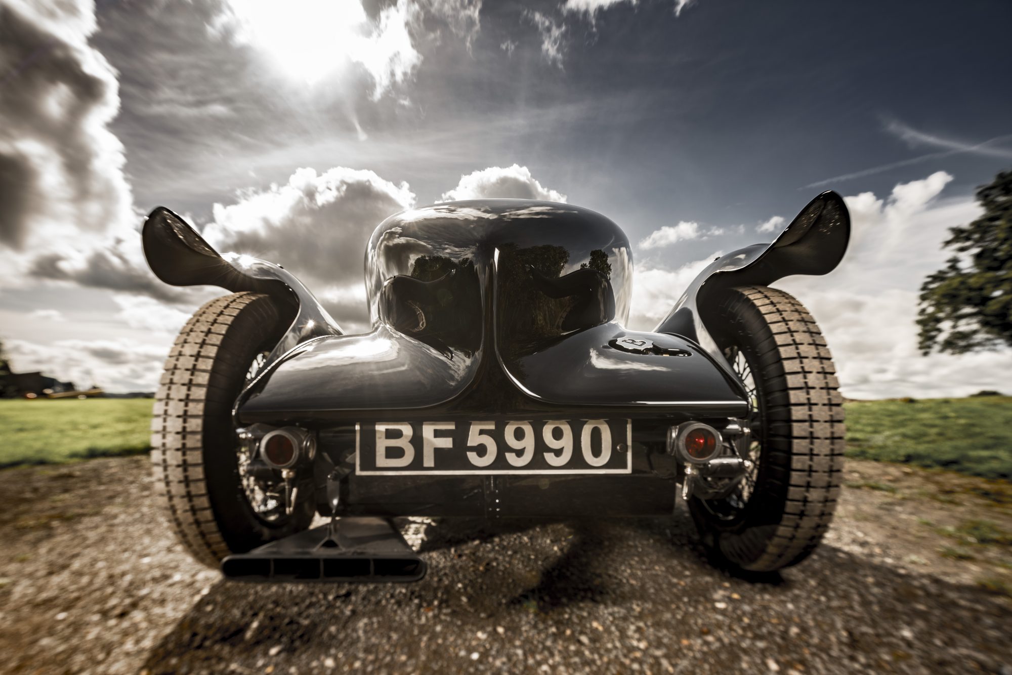 Low wide-angle view of the rear wings flaring against a bright sky